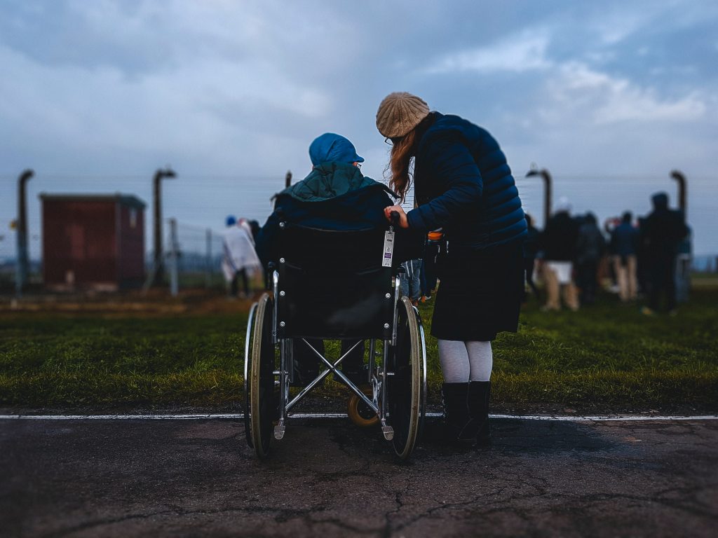 Person helping someone in wheelchair